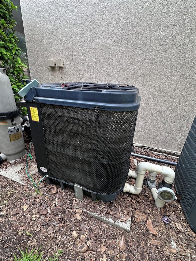 1452 Moon Valley Dr, Davenport, FL 33896 - exterior view of a central air condition unit and stucco siding