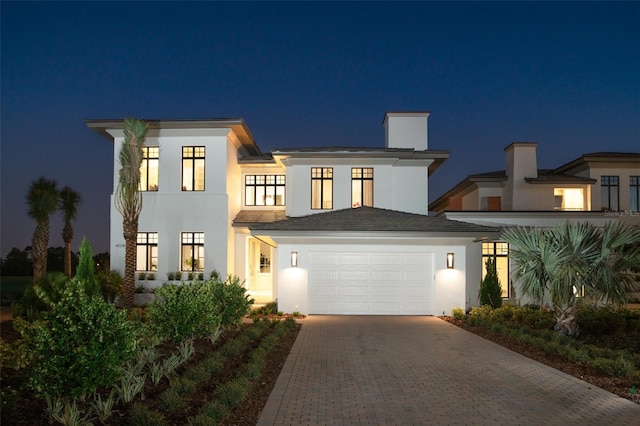 4007 Grande Brick Loop Unit 13, Orlando, FL 32837 - contemporary home with stucco siding, decorative driveway, and an attached garage