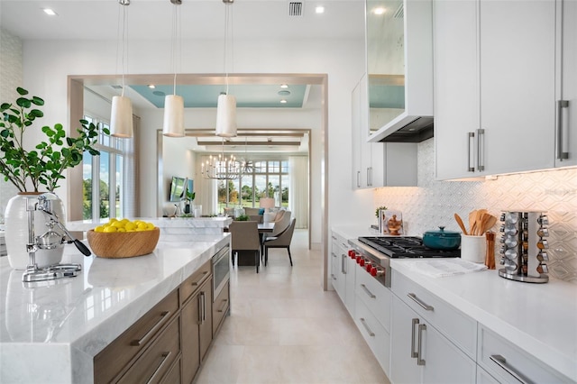 4007 Grande Brick Loop Unit 13, Orlando, FL 32837 - kitchen featuring appliances with stainless steel finishes, backsplash, white cabinets, glass insert cabinets, and decorative light fixtures