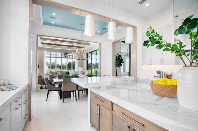 4007 Grande Brick Loop Unit 13, Orlando, FL 32837 - kitchen featuring light stone countertops, a chandelier, hanging light fixtures, and recessed lighting