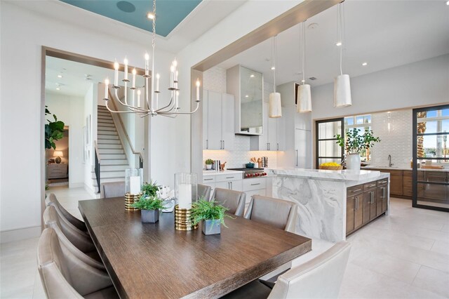 4007 Grande Brick Loop Unit 13, Orlando, FL 32837 - dining room with a chandelier, stairs, a towering ceiling, and recessed lighting