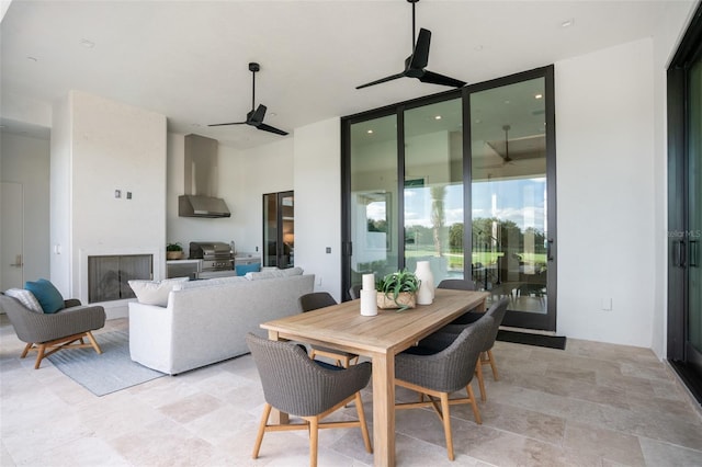 4007 Grande Brick Loop Unit 13, Orlando, FL 32837 - dining area featuring ceiling fan, a fireplace, and stone finish floors