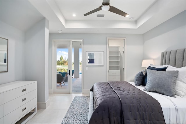 4007 Grande Brick Loop Unit 13, Orlando, FL 32837 - bedroom featuring a tray ceiling, access to outside, light tile patterned flooring, ceiling fan, and a walk in closet