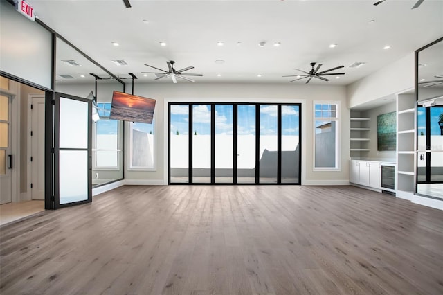 4007 Grande Brick Loop Unit 13, Orlando, FL 32837 - unfurnished living room with a ceiling fan, recessed lighting, built in shelves, wood finished floors, and beverage cooler