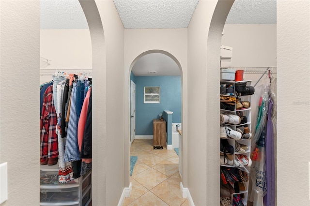 2042 Hayfield Way, Apopka, FL 32712 - hall with arched walkways, light tile patterned floors, and a textured ceiling