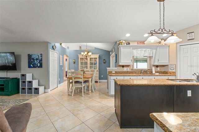 2042 Hayfield Way, Apopka, FL 32712 - kitchen featuring a chandelier, white cabinets, hanging light fixtures, decorative backsplash, and a textured ceiling