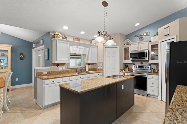 2042 Hayfield Way, Apopka, FL 32712 - kitchen featuring stainless steel appliances, lofted ceiling, decorative backsplash, white cabinetry, and recessed lighting