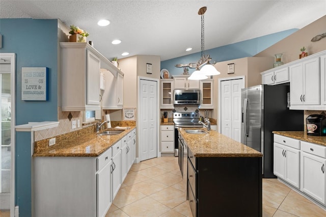 2042 Hayfield Way, Apopka, FL 32712 - kitchen featuring stainless steel appliances, a kitchen island with sink, backsplash, glass insert cabinets, and light tile patterned flooring