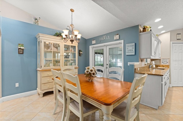 2042 Hayfield Way, Apopka, FL 32712 - dining space featuring a chandelier, french doors, lofted ceiling, light tile patterned flooring, and a textured ceiling