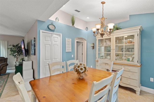 2042 Hayfield Way, Apopka, FL 32712 - dining area featuring light tile patterned flooring, a chandelier, arched walkways, and a textured ceiling