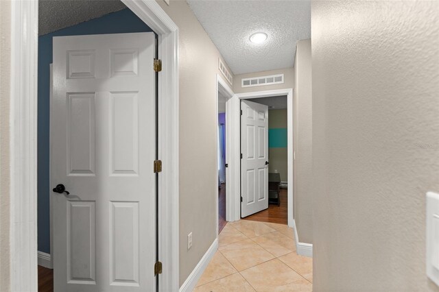 2042 Hayfield Way, Apopka, FL 32712 - corridor featuring a textured ceiling and light tile patterned floors