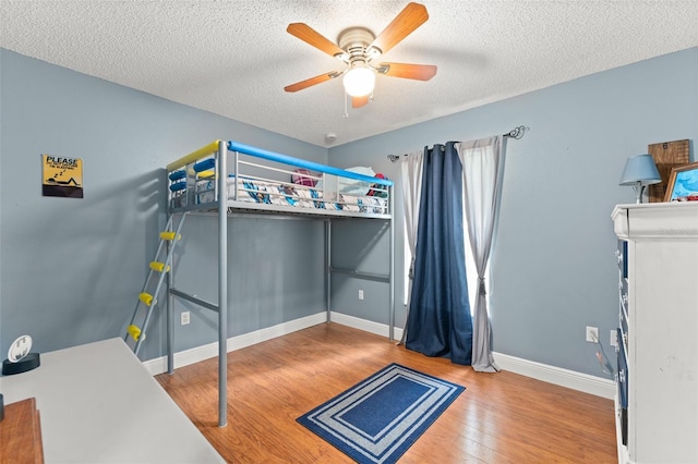 2042 Hayfield Way, Apopka, FL 32712 - bedroom with wood finished floors, a textured ceiling, and a ceiling fan