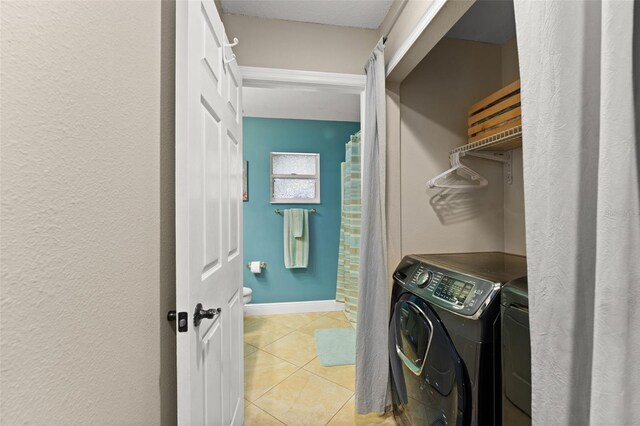 2042 Hayfield Way, Apopka, FL 32712 - washroom featuring washing machine and clothes dryer and light tile patterned flooring