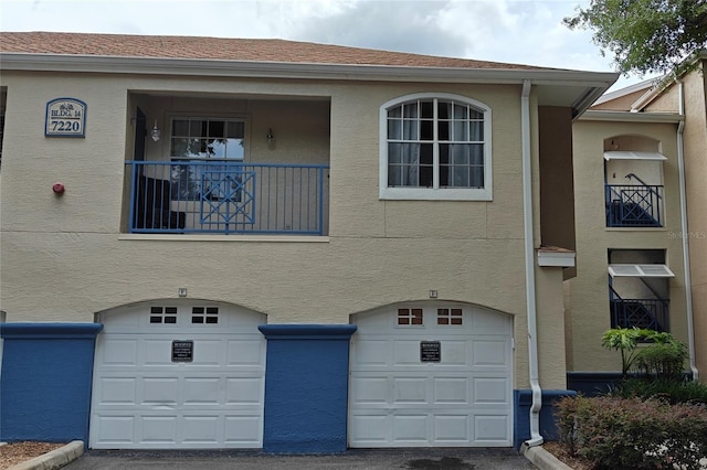 7220 Westpointe Blvd Unit 1429, Orlando, FL 32835 - view of front facade with an attached garage and stucco siding