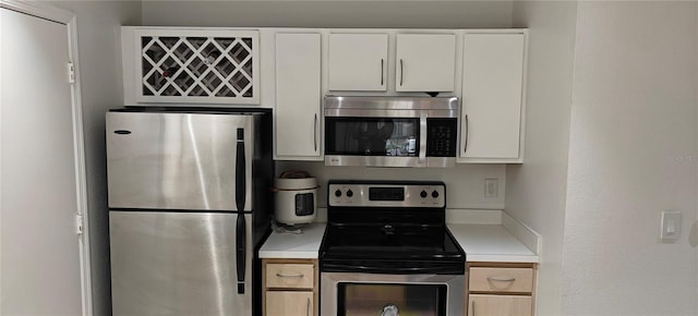 7220 Westpointe Blvd Unit 1429, Orlando, FL 32835 - kitchen with stainless steel appliances, light countertops, and white cabinetry