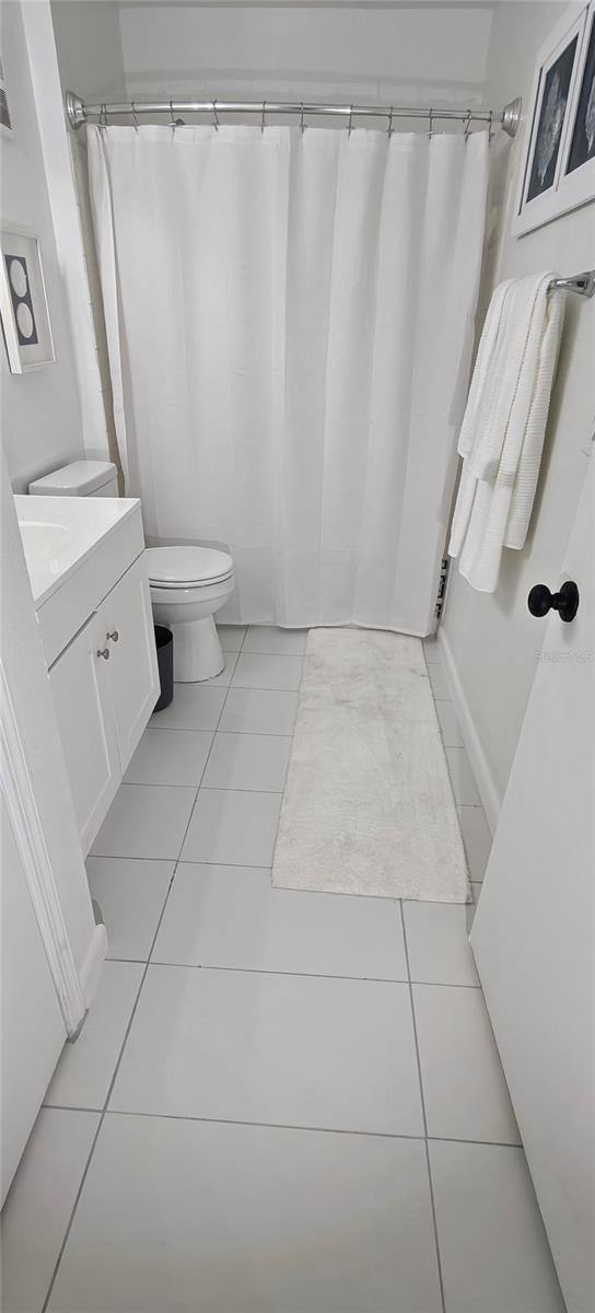 7220 Westpointe Blvd Unit 1429, Orlando, FL 32835 - full bathroom featuring tile patterned floors, vanity, and curtained shower