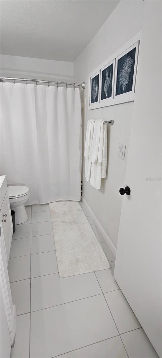 7220 Westpointe Blvd Unit 1429, Orlando, FL 32835 - bathroom featuring tile patterned flooring, vanity, and a shower with shower curtain
