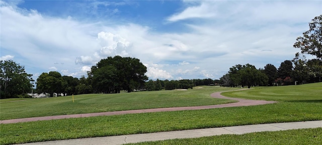 7220 Westpointe Blvd Unit 1429, Orlando, FL 32835 - view of community featuring view of golf course, view of scattered trees, and a lawn