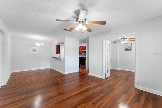 2041 Dixie Belle Dr Unit 2041C, Orlando, FL 32812 - unfurnished living room with a chandelier, a ceiling fan, dark wood-style flooring, and a textured ceiling