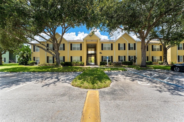 2041 Dixie Belle Dr Unit 2041C, Orlando, FL 32812 - multi unit property with stucco siding, uncovered parking, and a front yard