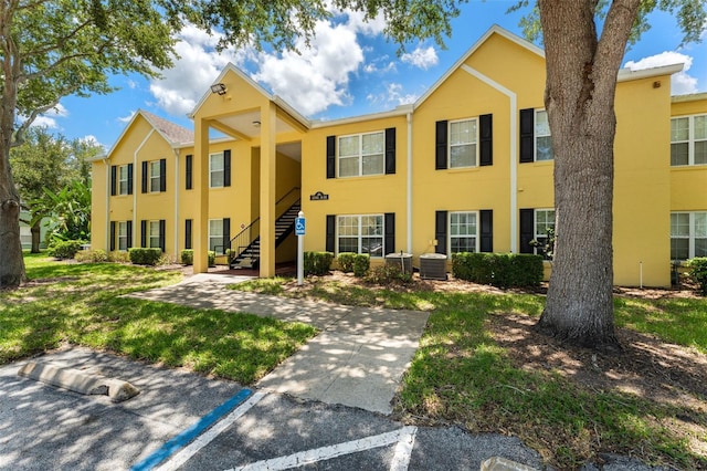 2041 Dixie Belle Dr Unit 2041C, Orlando, FL 32812 - view of front of home with stucco siding and stairs