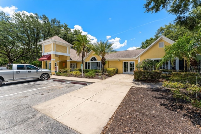 2041 Dixie Belle Dr Unit 2041C, Orlando, FL 32812 - view of front of home featuring french doors, uncovered parking, and stucco siding
