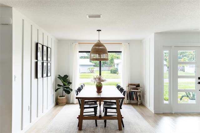 3920 Basswood Dr, Sarasota, FL 34232 - dining room featuring light wood-style floors and a textured ceiling