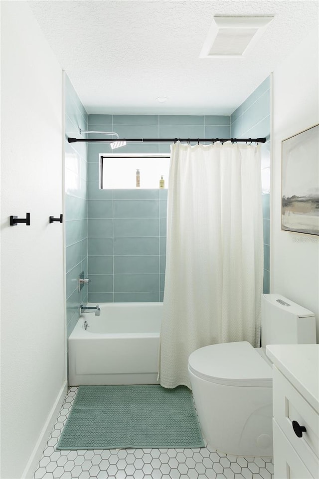 3920 Basswood Dr, Sarasota, FL 34232 - bathroom with shower / bath combo, vanity, tile patterned flooring, and a textured ceiling