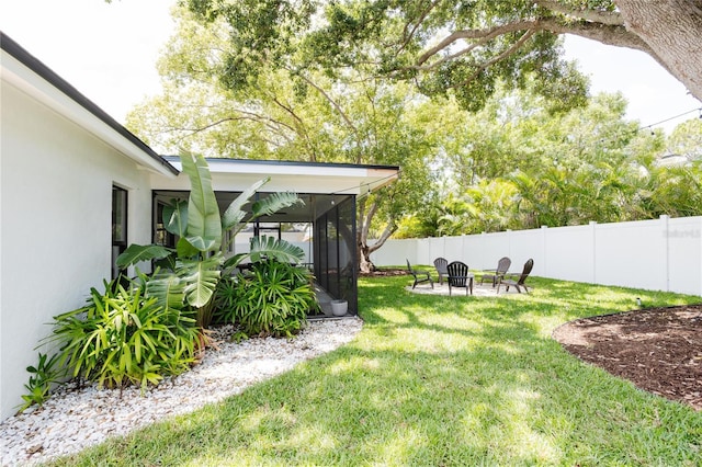 3920 Basswood Dr, Sarasota, FL 34232 - fenced backyard featuring a sunroom and a fire pit