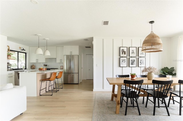 3920 Basswood Dr, Sarasota, FL 34232 - dining space featuring light wood-style floors