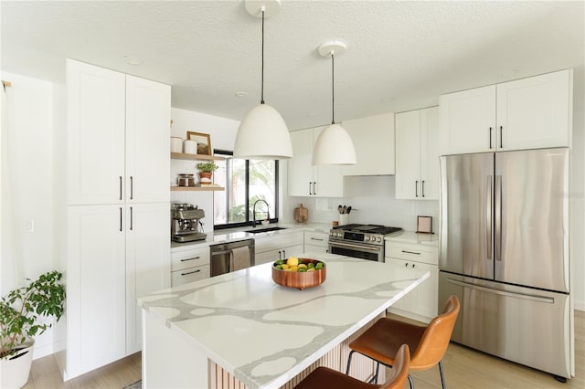 3920 Basswood Dr, Sarasota, FL 34232 - kitchen with stainless steel appliances, open shelves, a kitchen island, a breakfast bar area, and light stone countertops