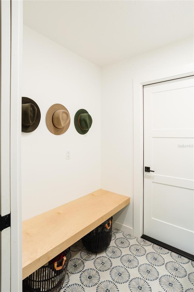 3920 Basswood Dr, Sarasota, FL 34232 - mudroom with light tile patterned floors and baseboards