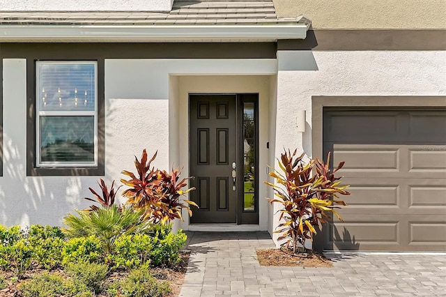4429 Ganesha Loop, Kissimmee, FL 34746 - property entrance featuring stucco siding and a garage