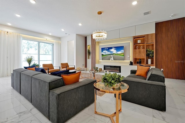 4429 Ganesha Loop, Kissimmee, FL 34746 - living room with light marble finish flooring, recessed lighting, and a chandelier