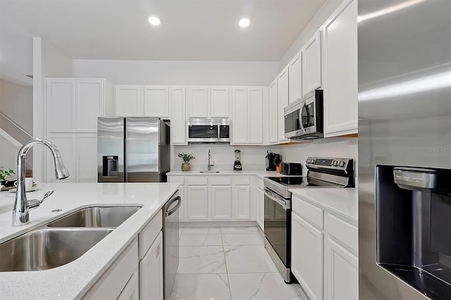 4429 Ganesha Loop, Kissimmee, FL 34746 - kitchen with stainless steel appliances, light marble finish floors, white cabinets, recessed lighting, and light stone counters