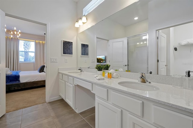 4429 Ganesha Loop, Kissimmee, FL 34746 - ensuite bathroom featuring double vanity, tile patterned flooring, a shower stall, and a chandelier