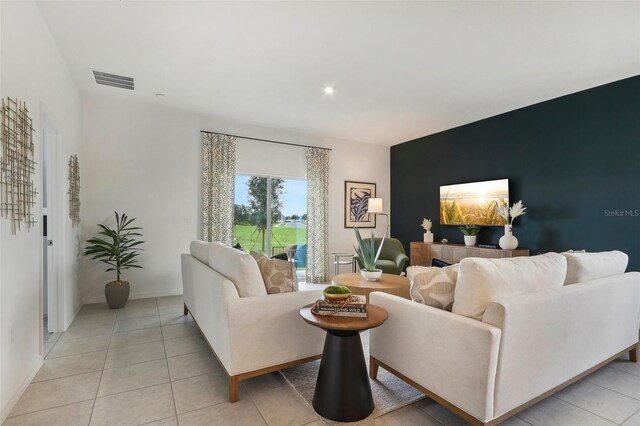 3220 Viridian Cir, West Melbourne, FL 32904 - living room with an accent wall, light tile patterned floors, and recessed lighting
