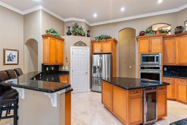 1224 Northern Way, Winter Springs, FL 32708 - kitchen featuring stainless steel appliances, beverage cooler, arched walkways, backsplash, and ornamental molding