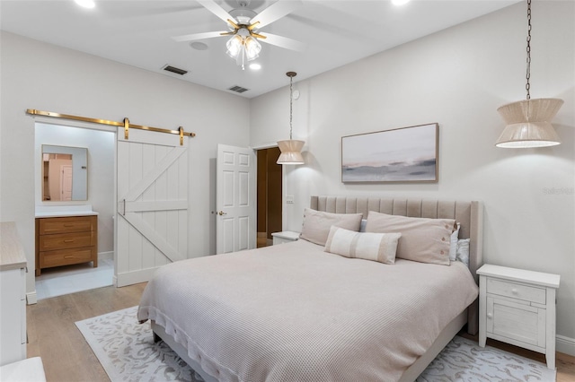 1224 Northern Way, Winter Springs, FL 32708 - bedroom with a barn door, light wood-type flooring, recessed lighting, and a ceiling fan