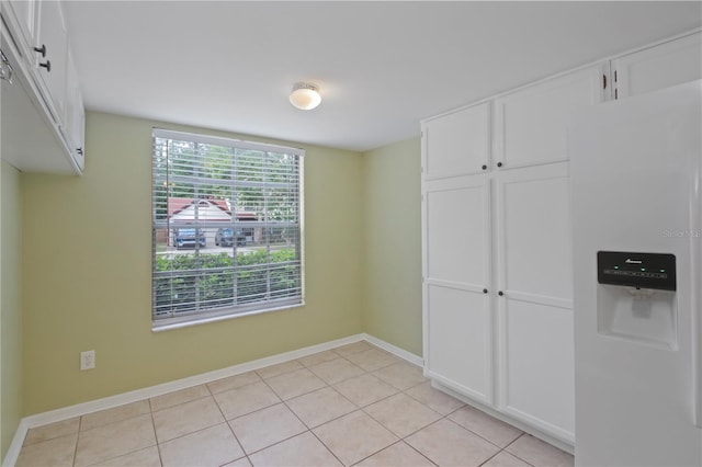 1026 Mccully Ct, Oviedo, FL 32765 - unfurnished bedroom with white fridge with ice dispenser, light tile patterned flooring, and a closet