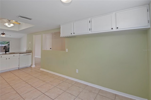 1026 Mccully Ct, Oviedo, FL 32765 - kitchen with dishwasher, a ceiling fan, light tile patterned floors, white cabinetry, and a raised ceiling