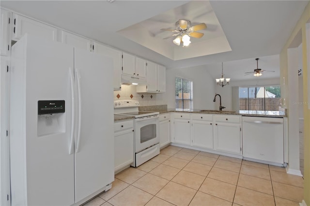 1026 Mccully Ct, Oviedo, FL 32765 - kitchen with white appliances, under cabinet range hood, a ceiling fan, a tray ceiling, and white cabinets