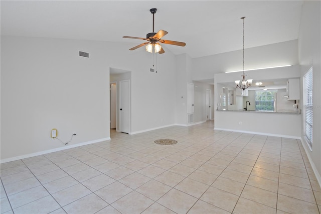 1026 Mccully Ct, Oviedo, FL 32765 - unfurnished living room with a chandelier, a ceiling fan, light tile patterned floors, and high vaulted ceiling
