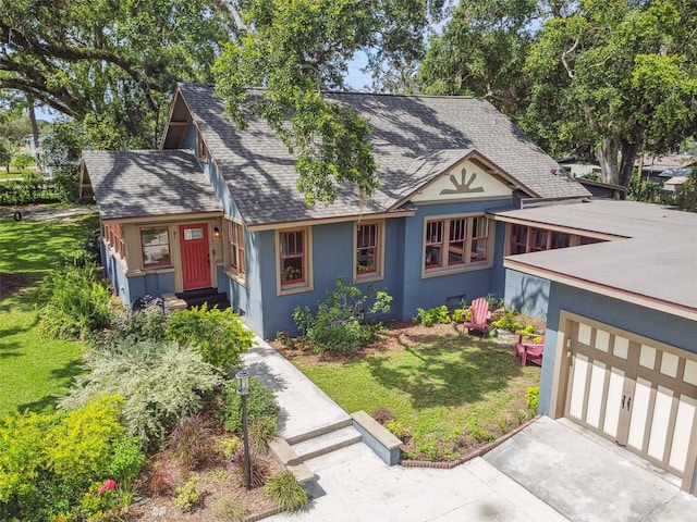 524 S Lakeview Ave, Winter Garden, FL 34787 - tudor home with entry steps, roof with shingles, stucco siding, a front lawn, and driveway