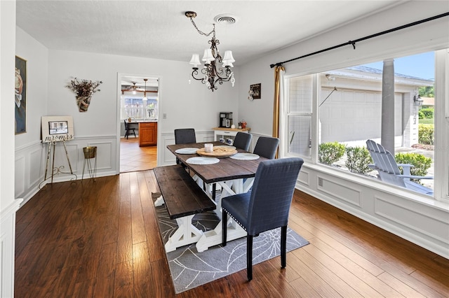 2220 Derbyshire Rd, Maitland, FL 32751 - dining room featuring a decorative wall, wood-type flooring, a chandelier, and a wainscoted wall