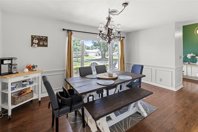 2220 Derbyshire Rd, Maitland, FL 32751 - dining room with a chandelier, dark wood-type flooring, wainscoting, and a decorative wall