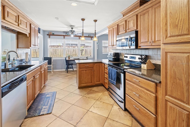2220 Derbyshire Rd, Maitland, FL 32751 - kitchen featuring stainless steel appliances, ceiling fan, light tile patterned floors, tasteful backsplash, and a peninsula