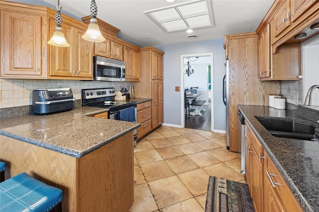 2220 Derbyshire Rd, Maitland, FL 32751 - kitchen with appliances with stainless steel finishes, tasteful backsplash, dark stone countertops, hanging light fixtures, and light tile patterned floors