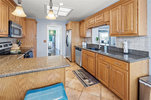 2220 Derbyshire Rd, Maitland, FL 32751 - kitchen with appliances with stainless steel finishes, tasteful backsplash, dark stone countertops, hanging light fixtures, and light tile patterned floors