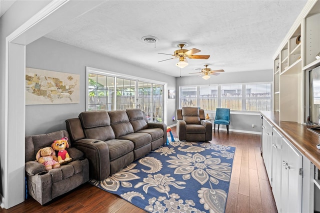 2220 Derbyshire Rd, Maitland, FL 32751 - living room with dark wood-style flooring, a ceiling fan, and a textured ceiling